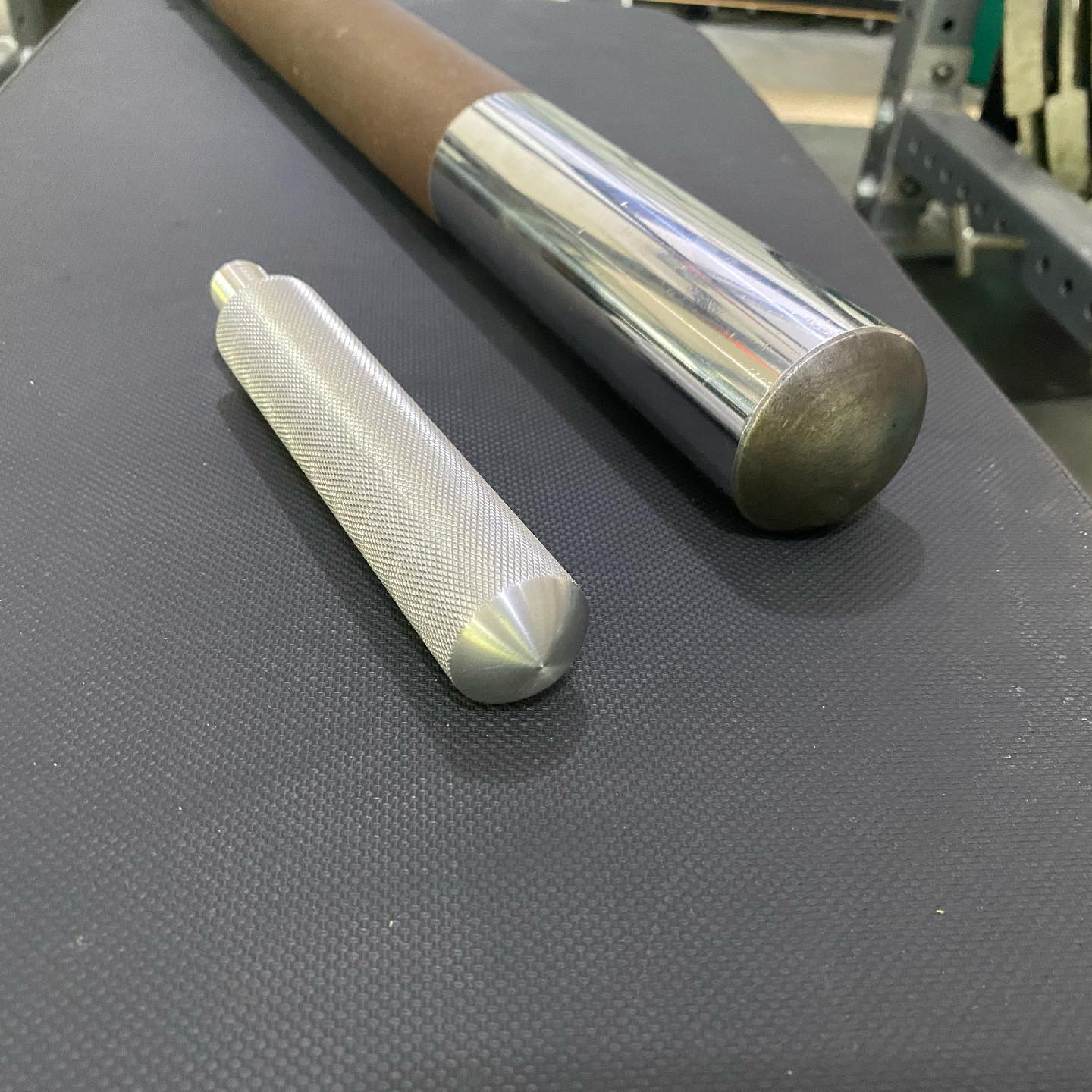 Close-up of Iron Pillow machined aluminum knurled handle and steel roller